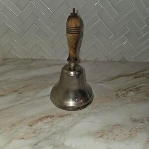Vintage brass school bell with wooden handle. brass bell, wooden handle